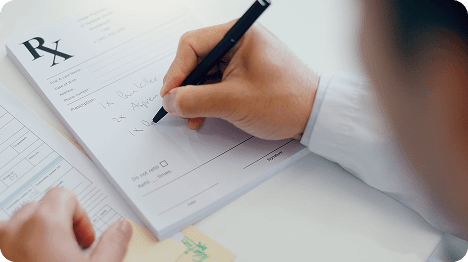 Medical professional writing on a prescription pad
